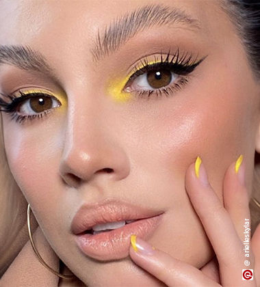 Model wearing yellow eyeshadow on inner corners of eyes