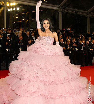 Nancy Tyagi wearing a pink floor-length gown with ruffles at the 77th Cannes Film Festival Red Carpet