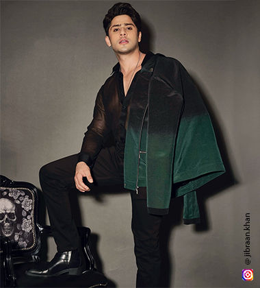 Jibraan Khan wearing an ombre green jacket 
