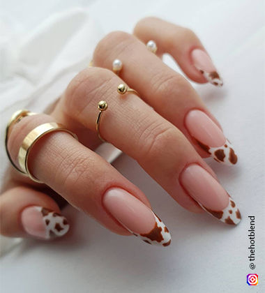 Cow-inspired nude nail art design