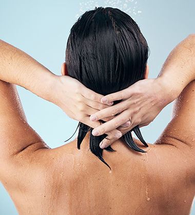 Woman’s damp hair in shower