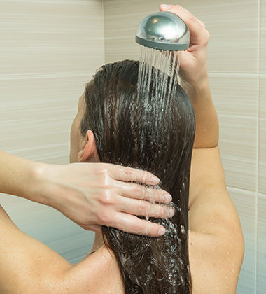 Woman rinsing hair 
