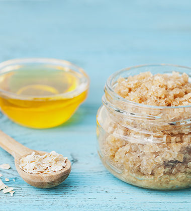 raw oats in a glass jar next to honey