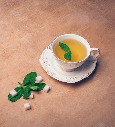 green tea placed next to sugar cubes