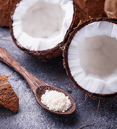 half cut coconuts and shredded coconuts in a spoon