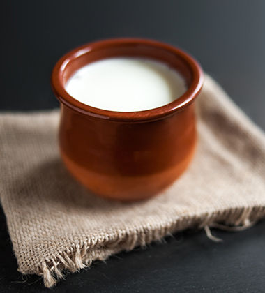 a bowl of yogurt over a piece of cloth