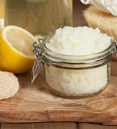 half cut lemon next to a bottle of coconut oil