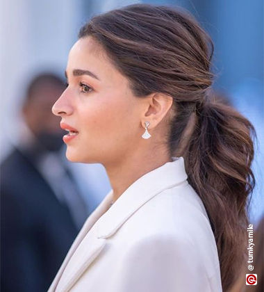 Hairstyles For Frizzy Hair- Messy Top Bun