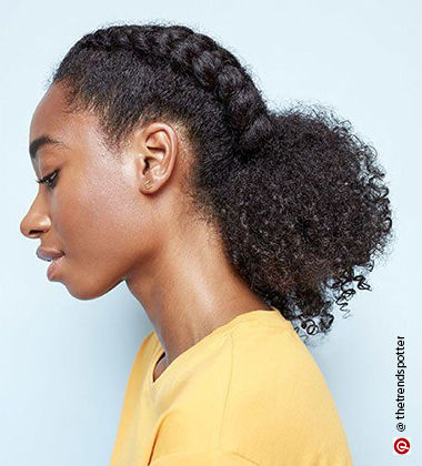 side profile of a woman with braided curls