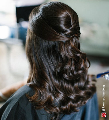 side profile of a woman with messy bun