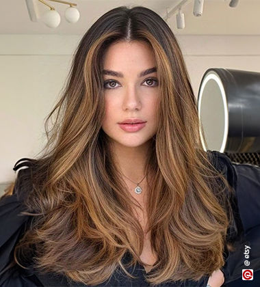 woman wearing a black top with a pendant
