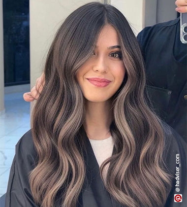 woman smiling into a mirror