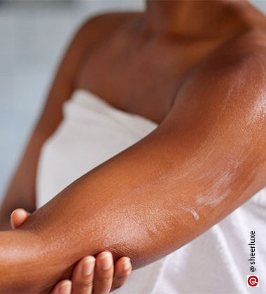 applying body lotion after shower