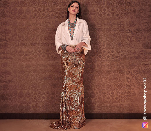 Shanaya Kapoor in a white oversized shirt and gold skirt