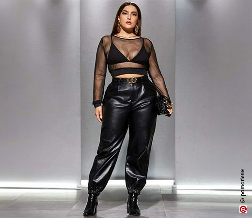 Woman wearing black sheer top and leather pants