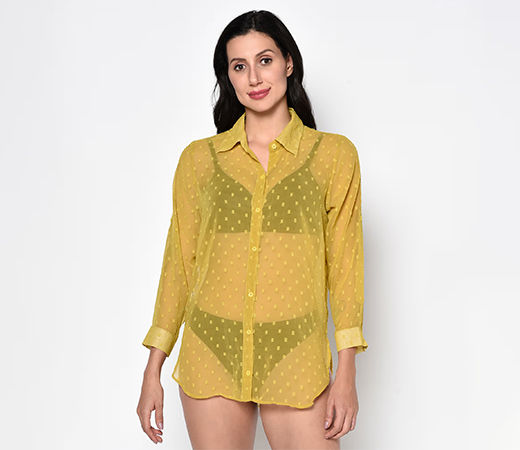 Woman wearing sheer yellow shirt over black two-piece swimwear 