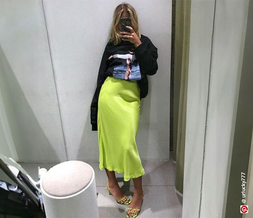 Woman wearing a graphic t-shirt with a midi skirt