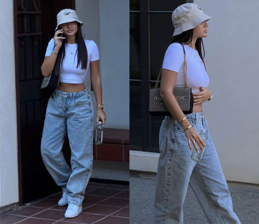 Woman wearing baggy jeans and a fitted crop top