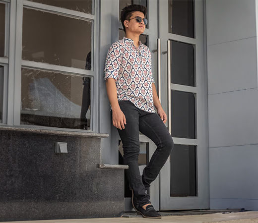 Model wearing a printed short kurta with grey jeans
