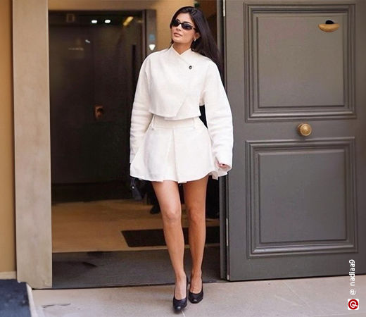 Kylie Jenner wearing a cropped jacket with a mini skirt