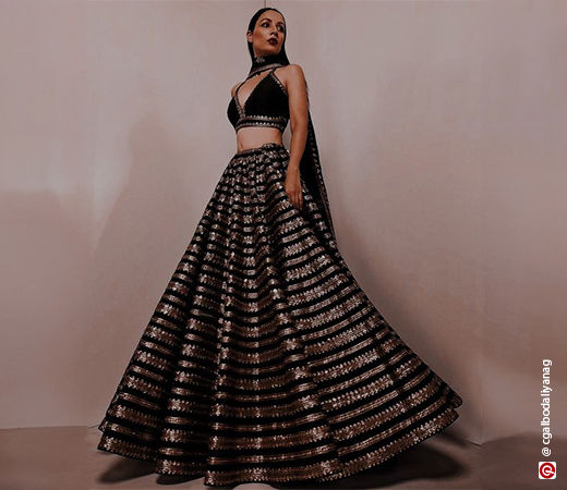 woman in a black lehenga with golden work on it