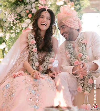 bride and groom in pink outfits