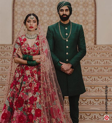 groom wearing green and bried wearing red
