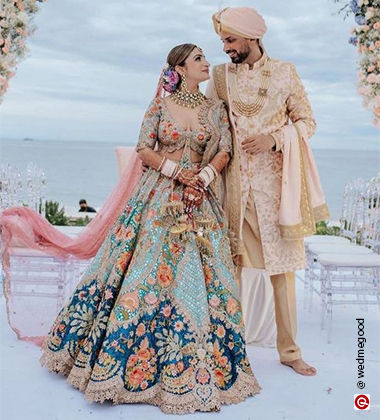 bride and groom in navy and cream outfits