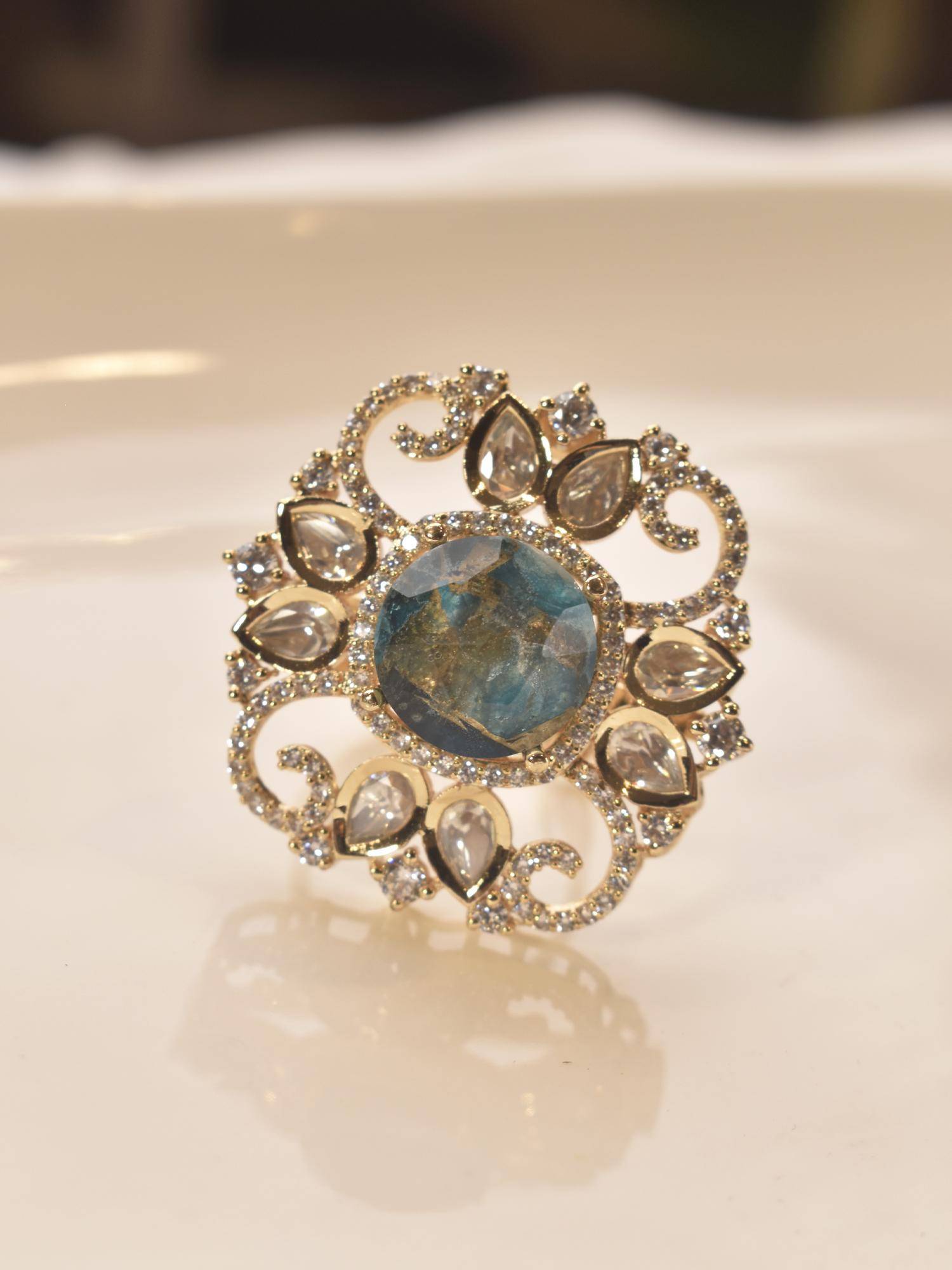 Peach Tassels Decorative Ring with a Blue Gemstone