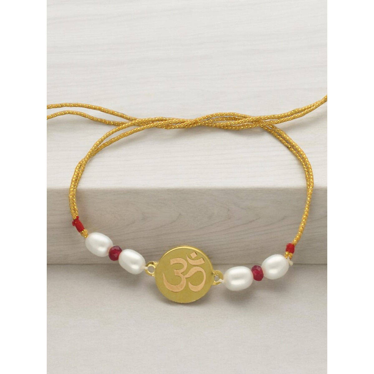 Sri Jagdamba Pearls 22Kt Om 1Gm Gold Rakhi