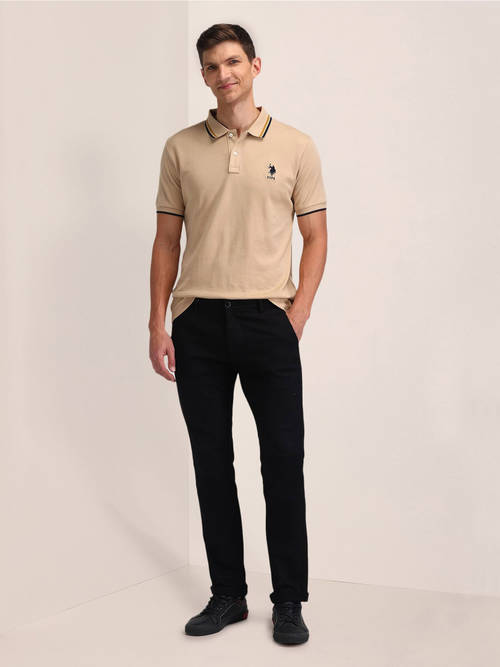 beige polo shirt with black pants