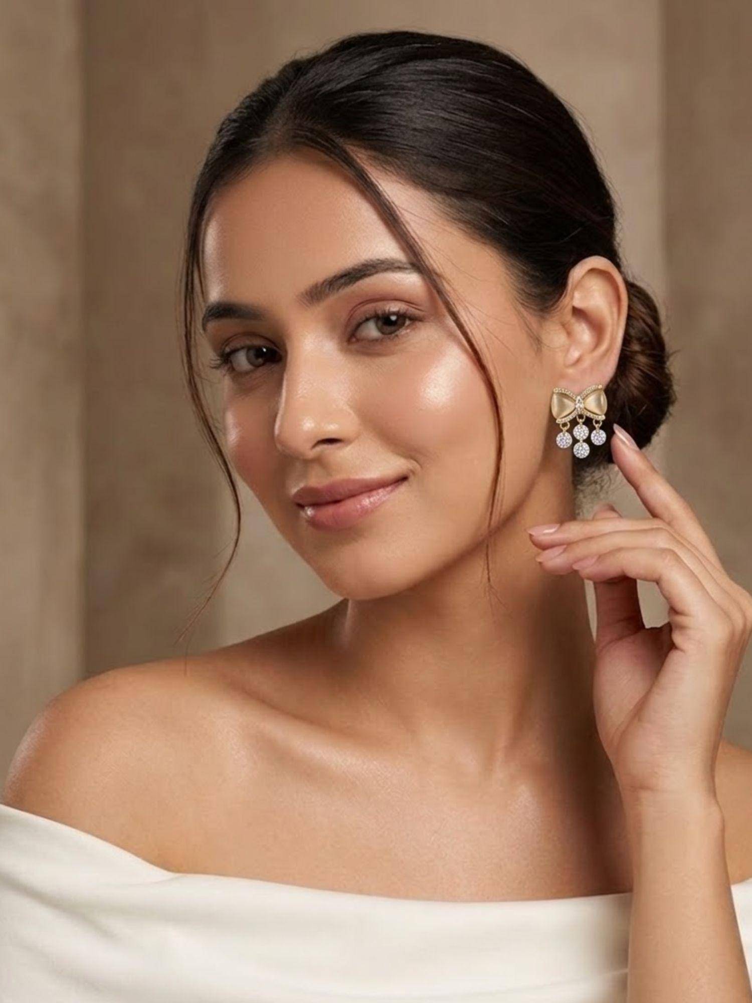 Niscka Gold Plated Bow Design Off White Statement Earrings
