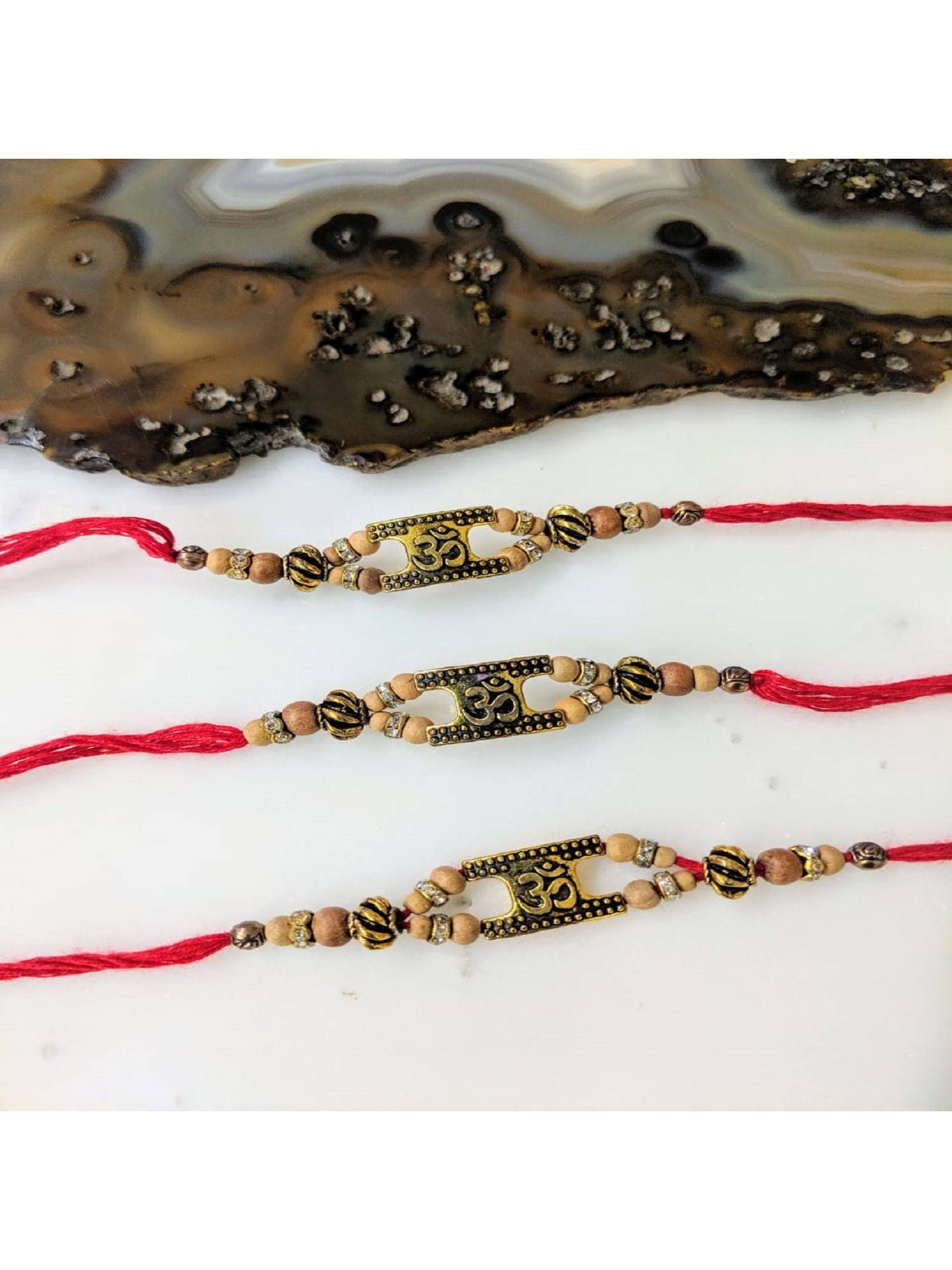 Digital Dress Room Gold Plated Om with Chandan Beads Rakhis (Pack of 3)