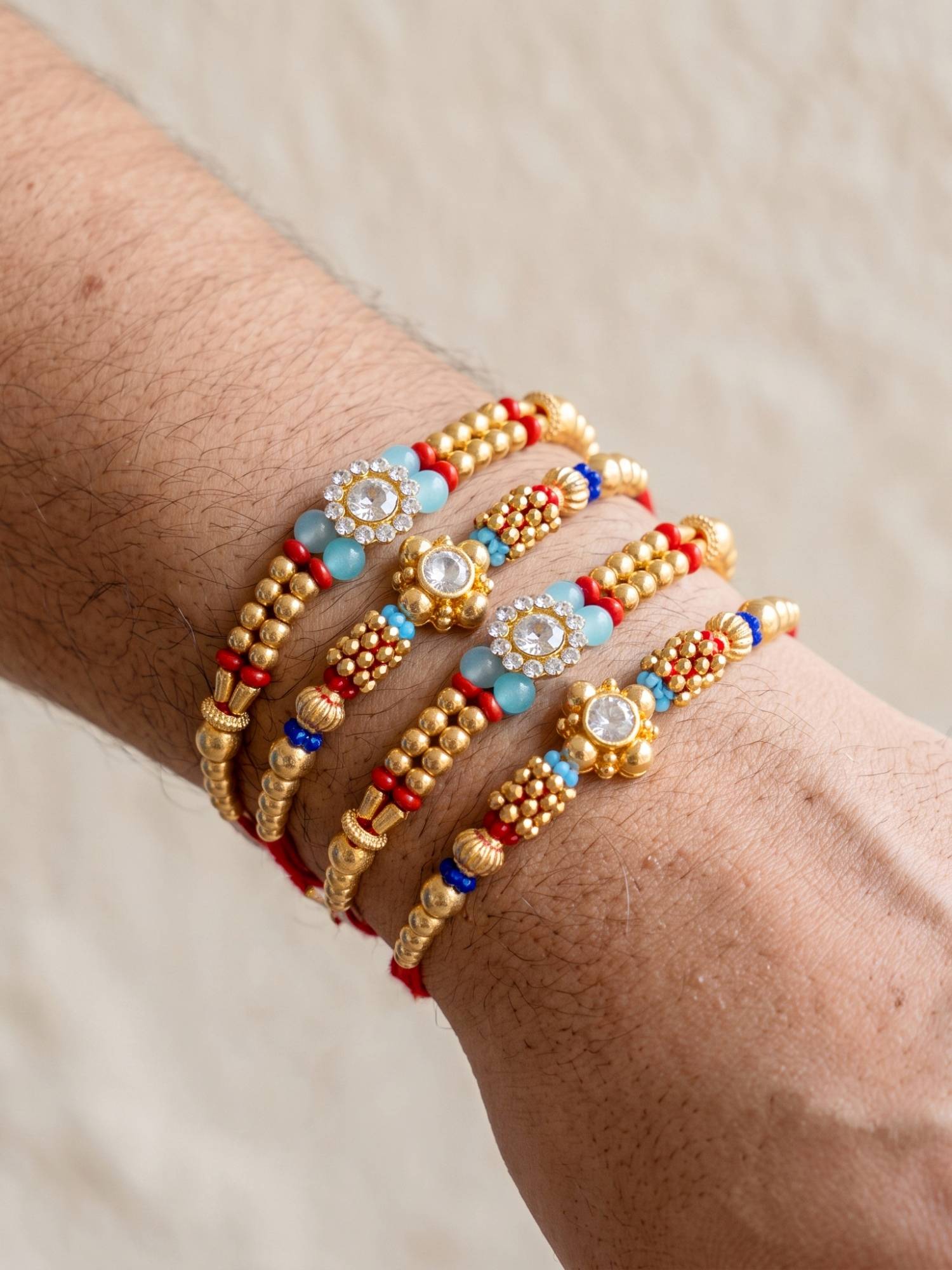 LUCKY JEWELLERY Designer Rakhi with Small Crystal Floral Centrepieces, Gold-Tone Beads (Pack of 4)