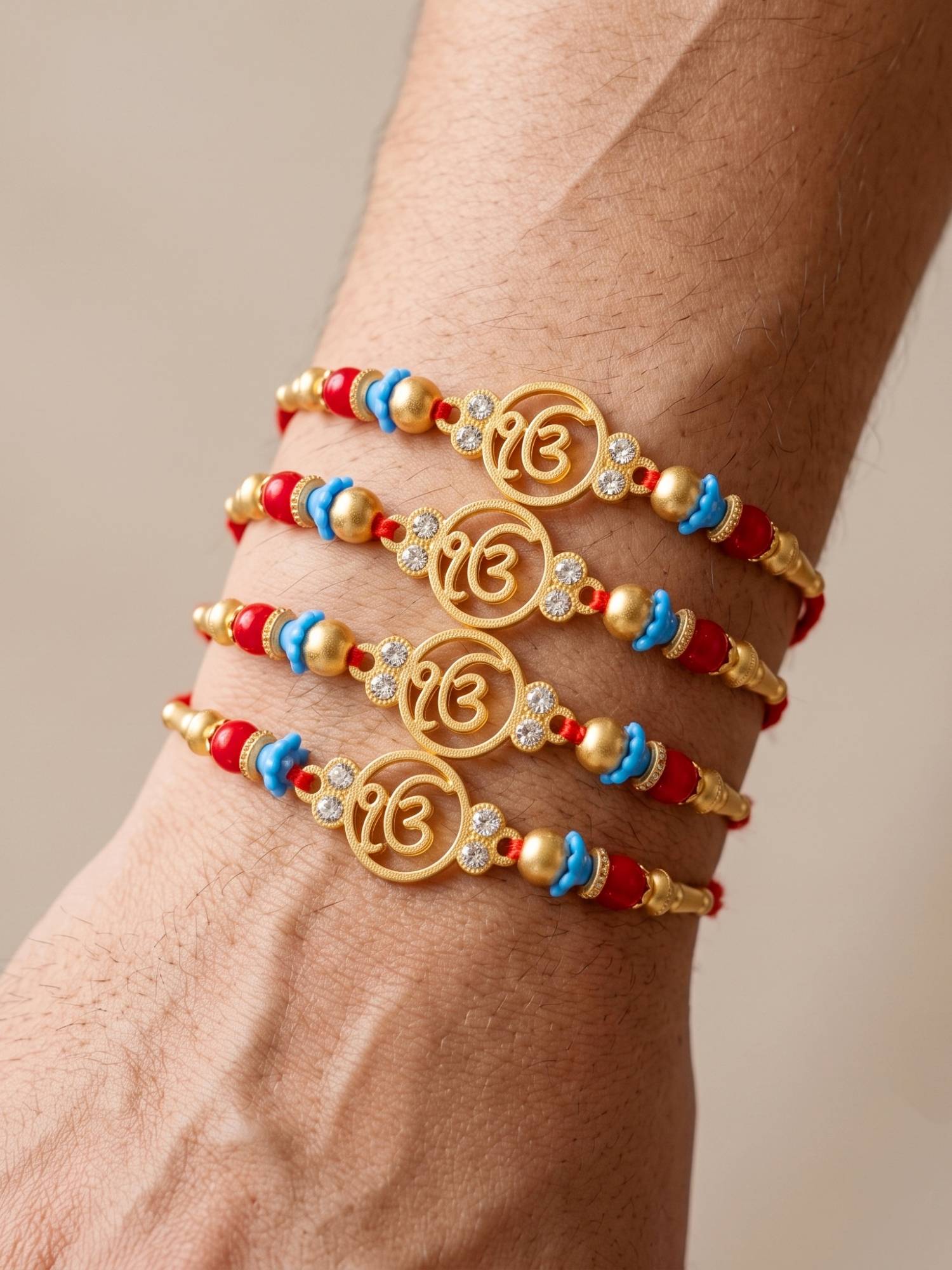 LUCKY JEWELLERY Rakhi with Ek Onkar Pendant, Maroon and Blue Beads, Roli Chawal and Card (Pack of 4)