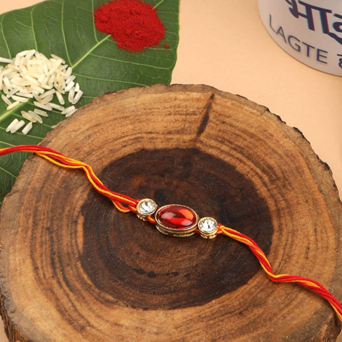 Accessher Traditional Delicate Ruby & Rhinestones Embellished Rakhi with Roli, Rice & Card