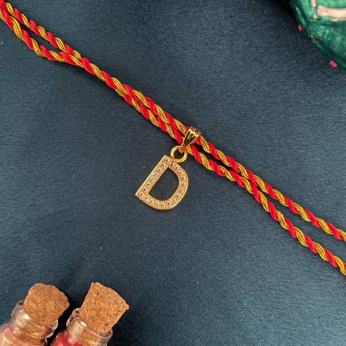 Digital Dress Room Gold D Letter Ad Red Thread Rakhi