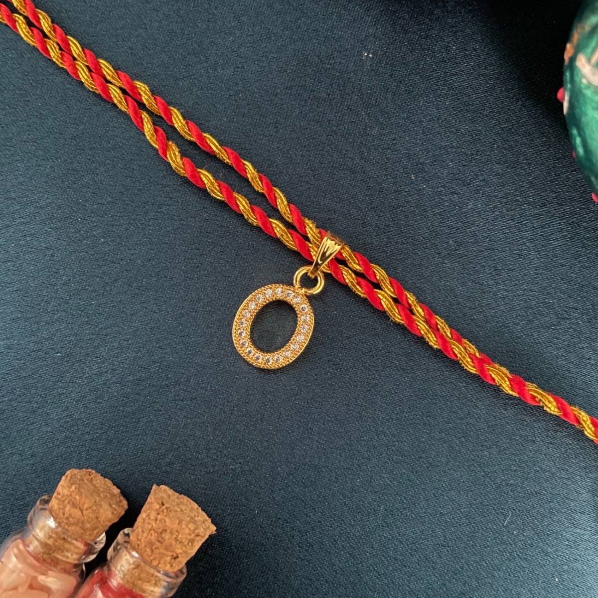 Digital Dress Room Gold O Letter Ad Red Thread Rakhi