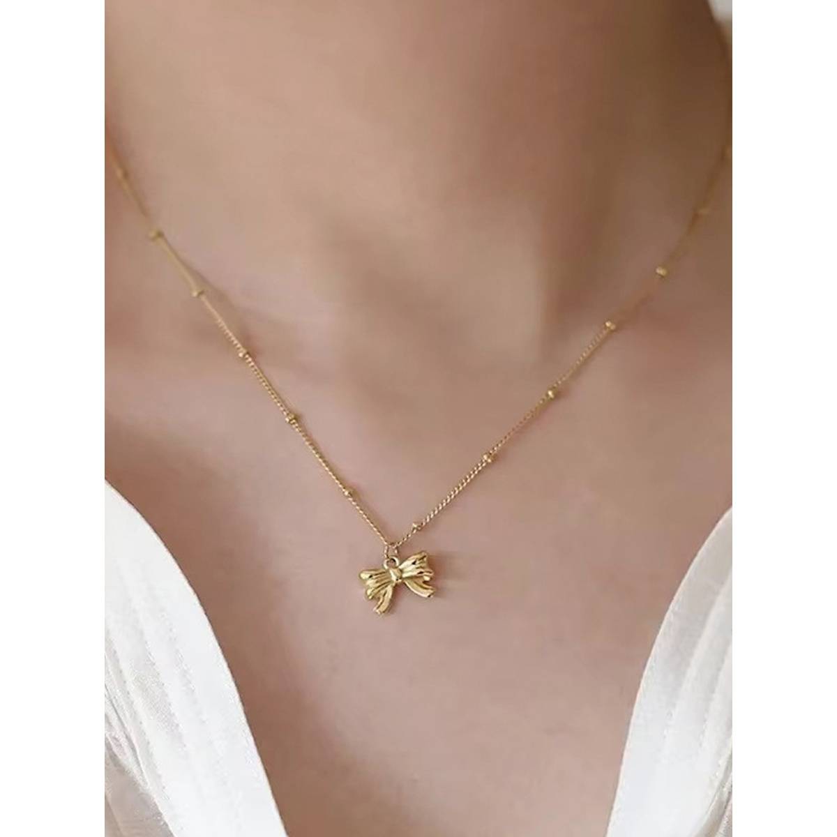 Designs & You Gold Plated Stainless Steel Anti Tarnish Bow Themed Pendant