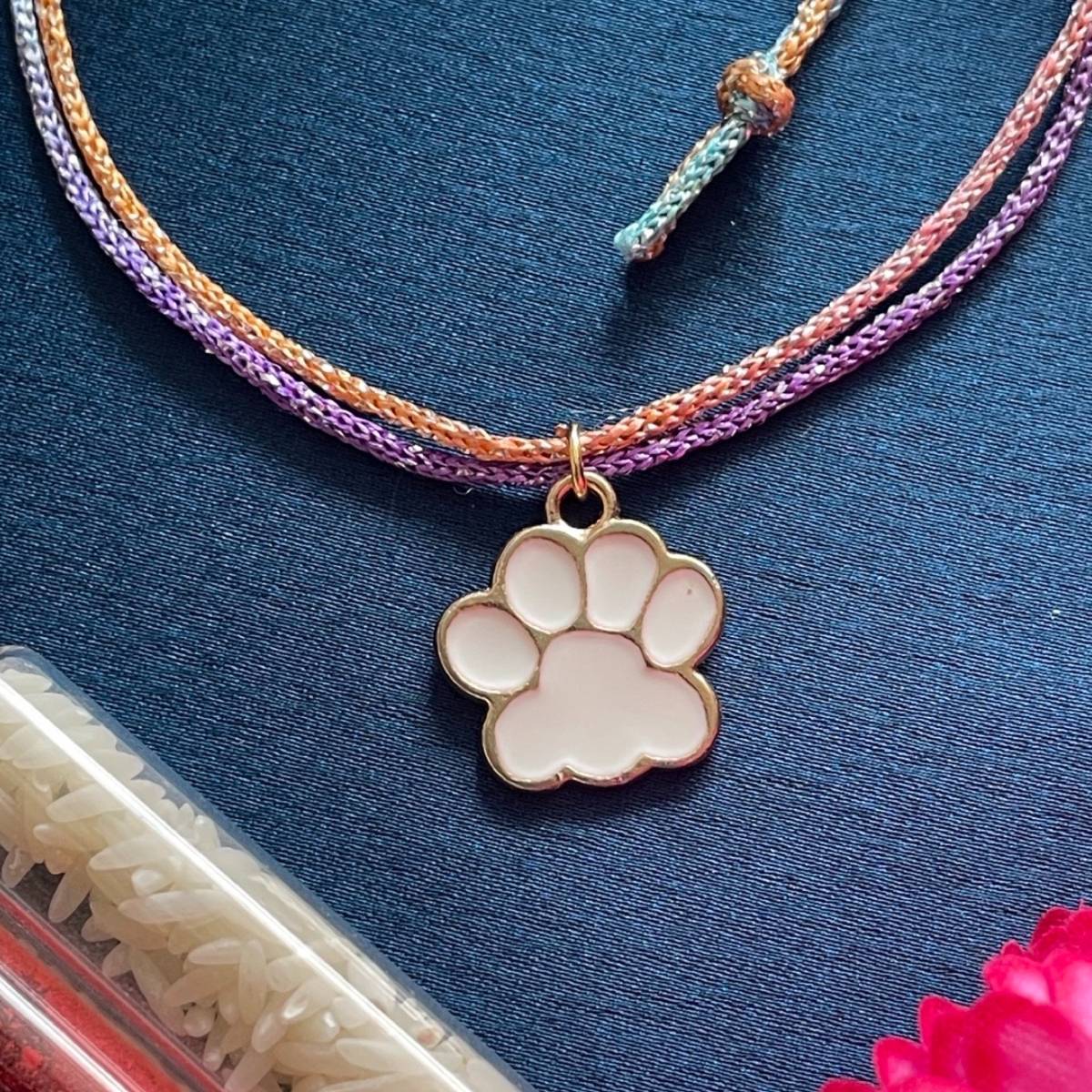 Digital Dress Room Gold Plated White Animal Paw Charm Rakhi For Raksha Bandhan