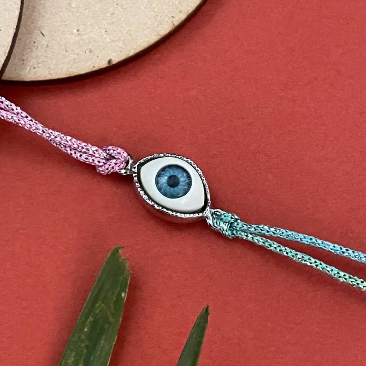 Digital Dress Room Gold Plated Oval Shape Evil Eye Charm Rakhi For Raksha Bandhan