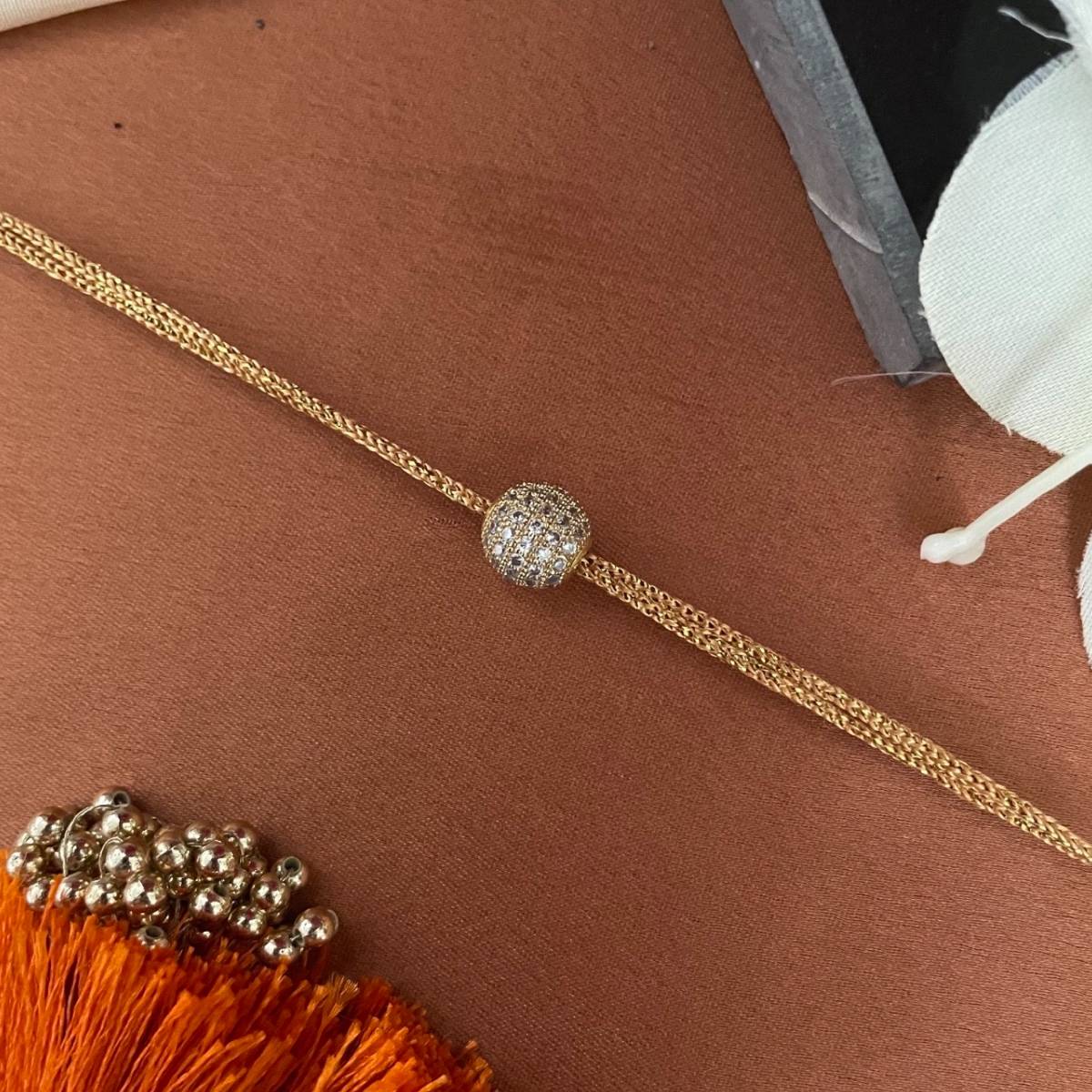 Digital Dress Room Gold Plated American Diamond Ball Pendant Rakhi For Raksha Bandhan