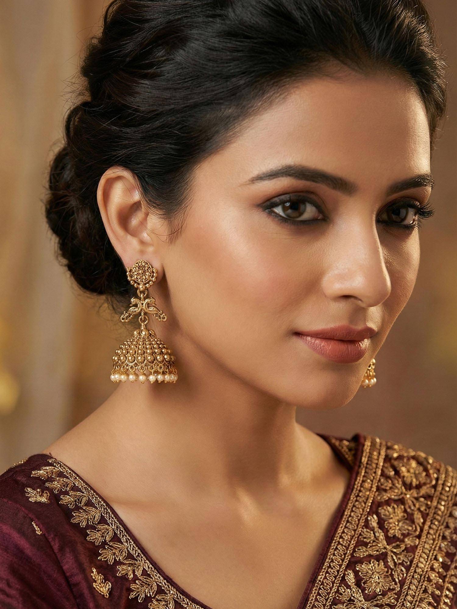 Niscka White Elegant Gold Plated Peacock Jhumka Earrings
