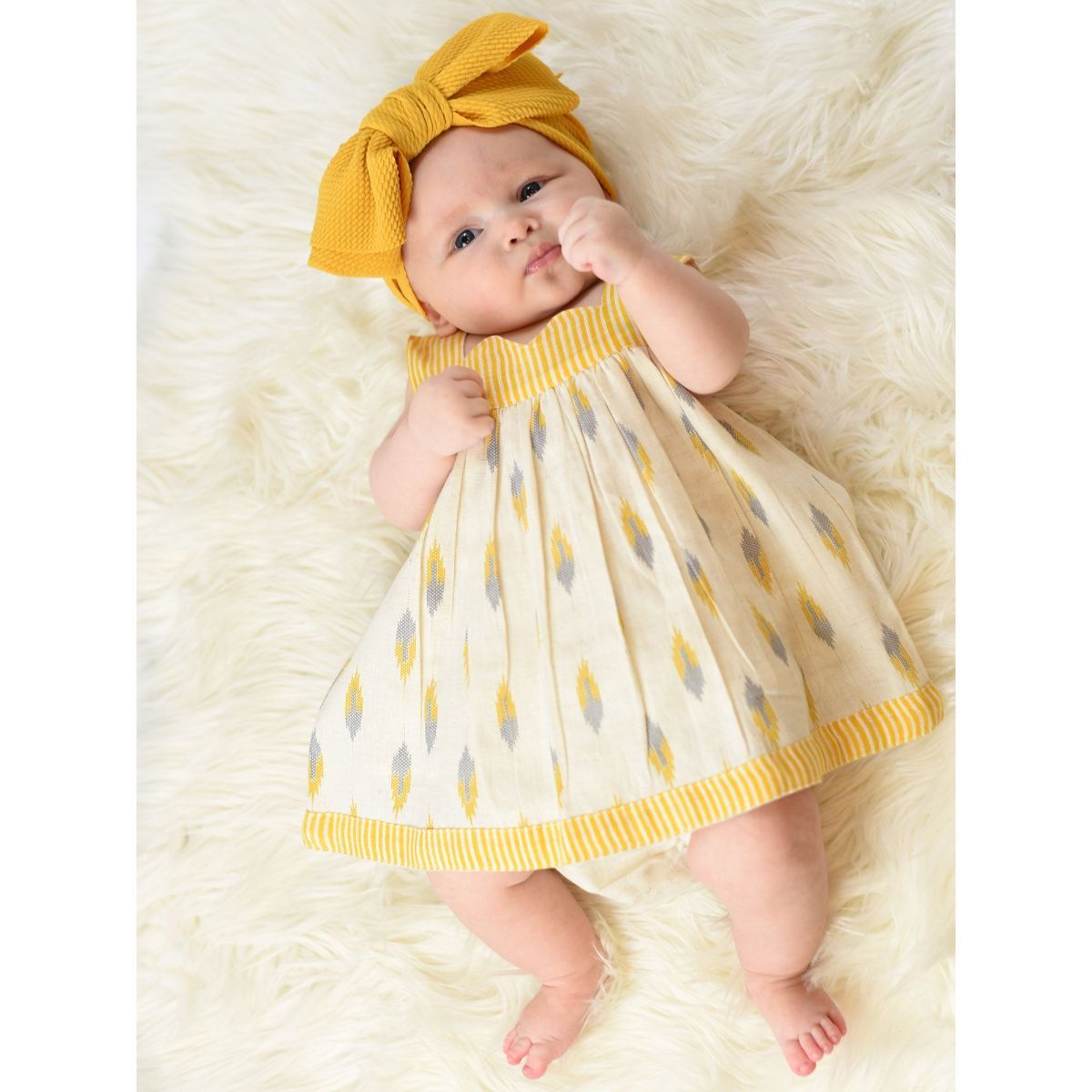 Cute baby girl in yellow band and dress sits in - stock photo 1552990 |  Crushpixel