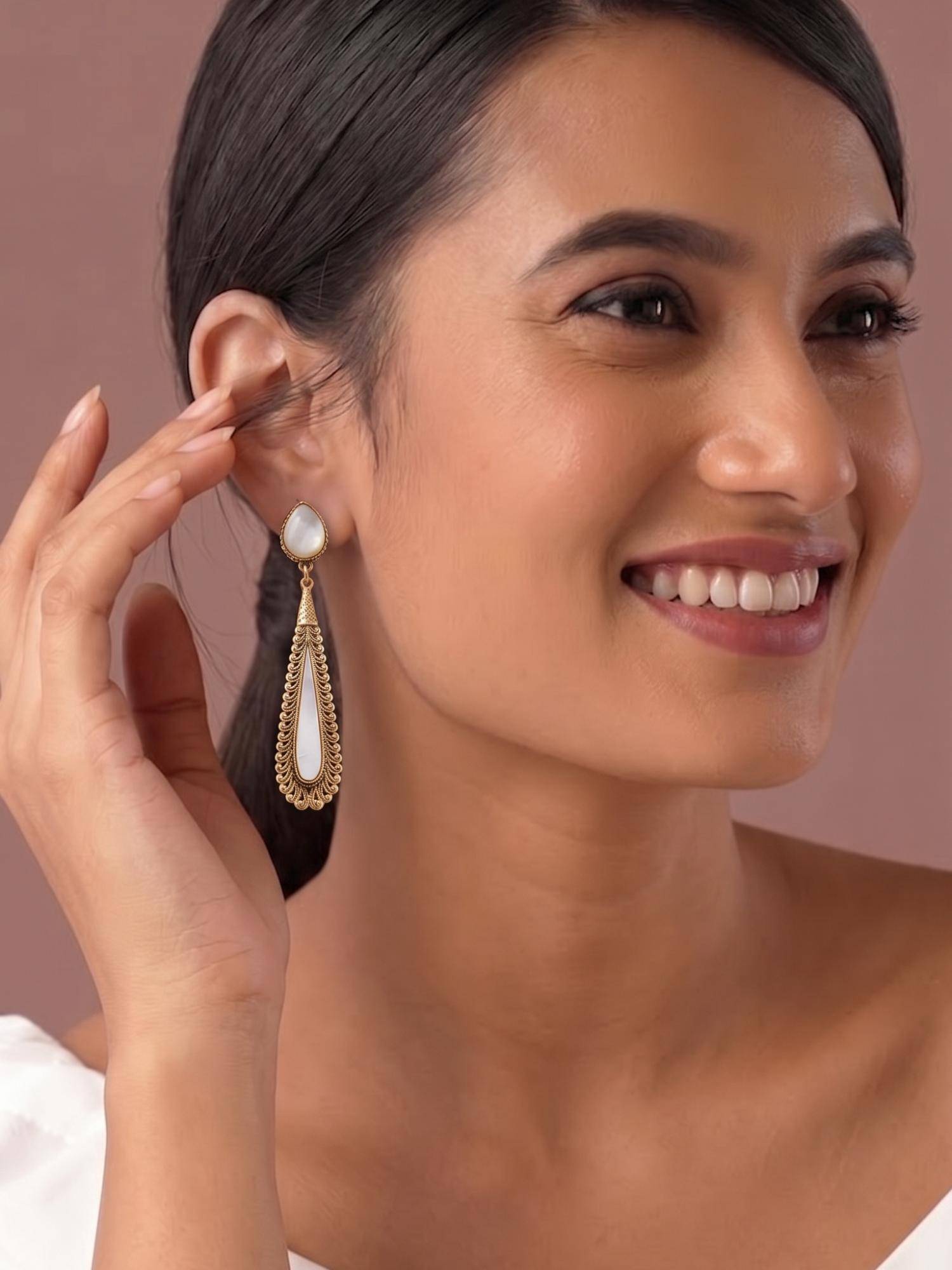 Niscka Matte Gold Plated Long Teardrop Filigree Dangler Earrings with White Stone